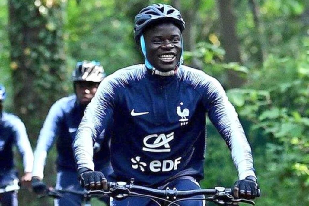 N'Golo Kante rides a bike.